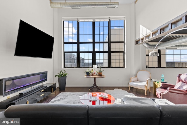 living room with a healthy amount of sunlight and dark wood-type flooring