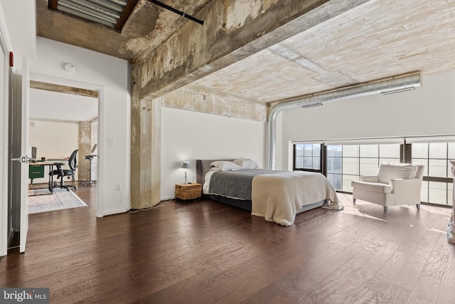 bedroom with dark hardwood / wood-style floors