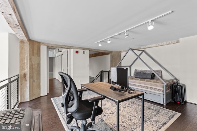 office space with dark wood-type flooring and rail lighting