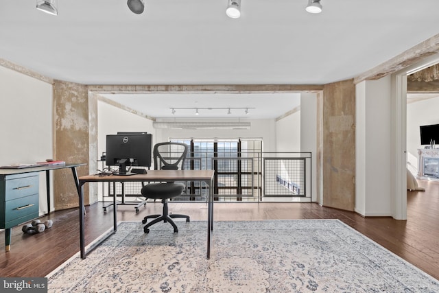 office featuring hardwood / wood-style flooring and rail lighting