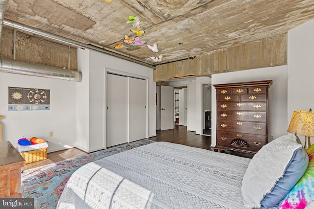 bedroom featuring dark hardwood / wood-style floors and a closet