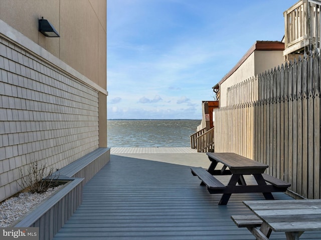 exterior space with outdoor dining area and a water view