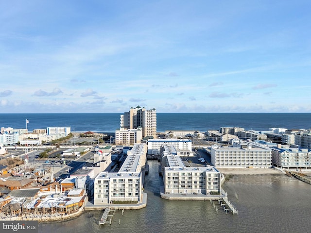 birds eye view of property featuring a view of city and a water view