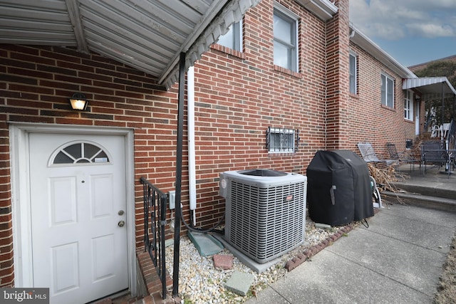 view of side of home with central AC