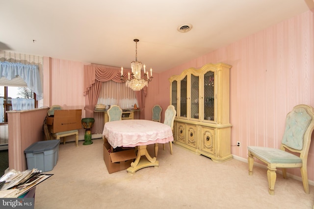 dining room with baseboard heating, carpet, and a notable chandelier