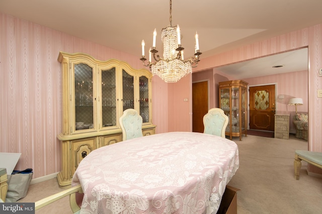 carpeted dining area with an inviting chandelier