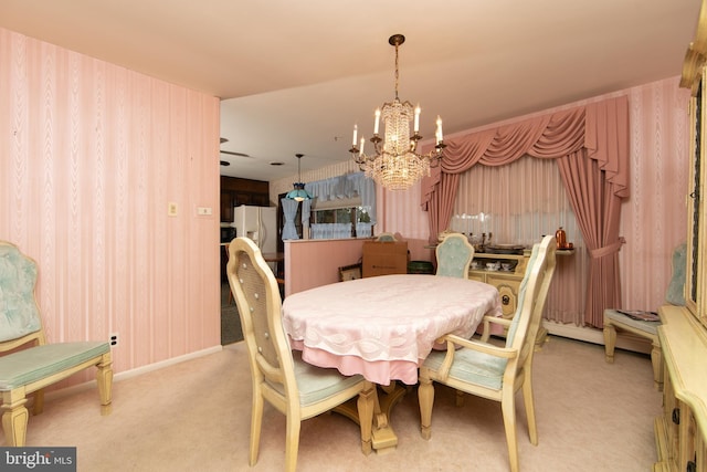 carpeted dining space featuring a chandelier