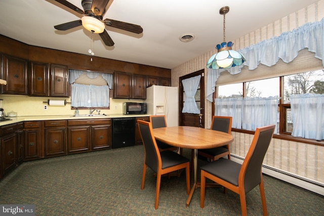 kitchen featuring sink, hanging light fixtures, a baseboard heating unit, dark brown cabinets, and black appliances