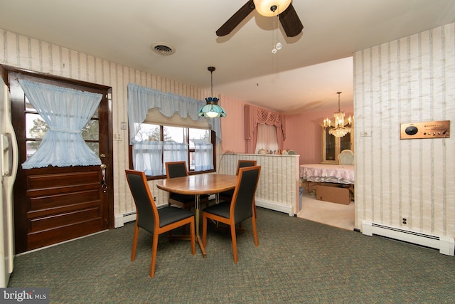 carpeted dining room with a baseboard radiator and ceiling fan