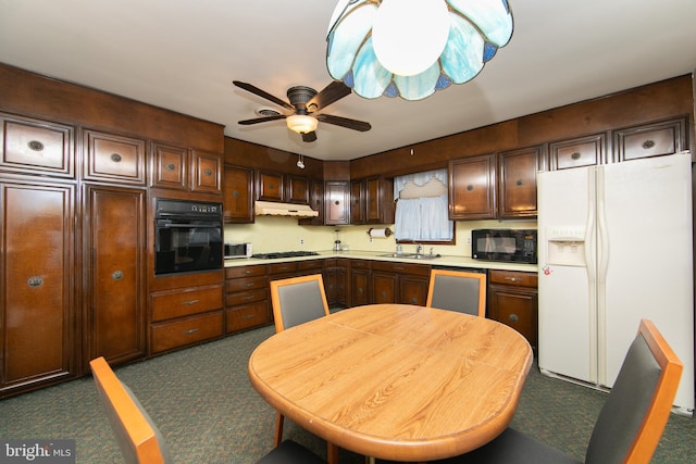 kitchen featuring ceiling fan, sink, dark brown cabinetry, and black appliances