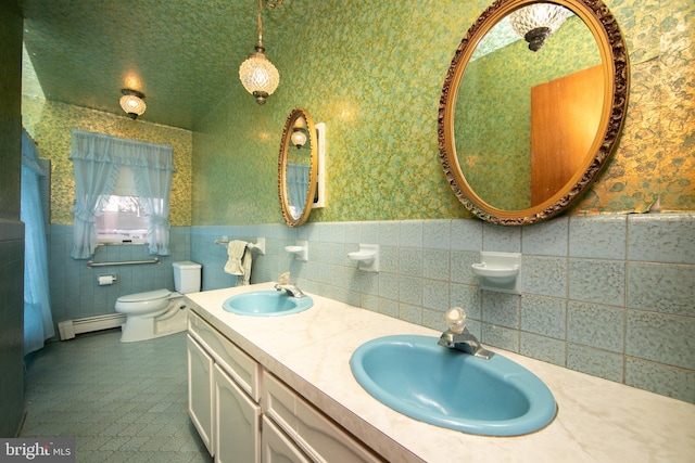 bathroom with toilet, vaulted ceiling, tile walls, a baseboard radiator, and vanity