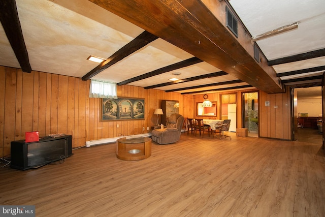 sitting room with hardwood / wood-style flooring, wood walls, beam ceiling, and a baseboard heating unit