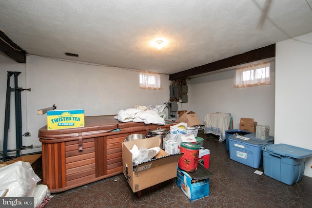 basement with electric panel and a textured ceiling