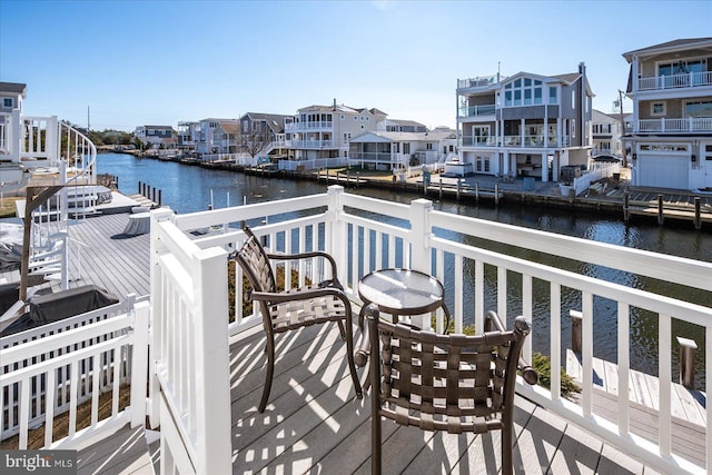 balcony featuring a residential view and a water view