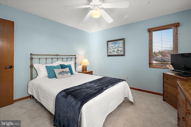 bedroom with baseboards, a ceiling fan, and light colored carpet