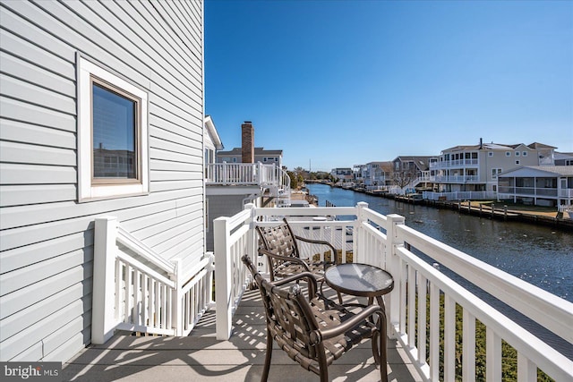 balcony featuring a water view and a residential view