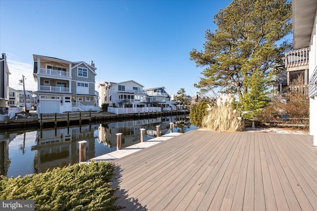 dock area with a water view and a residential view