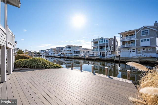 dock area with a water view and a residential view