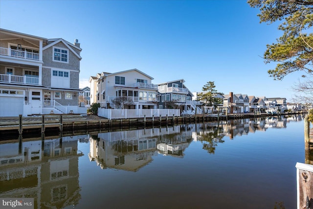 dock area with a water view and a residential view