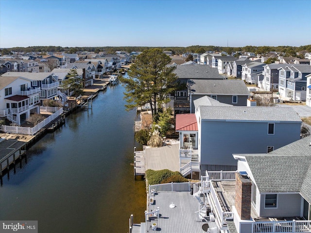 birds eye view of property featuring a water view and a residential view