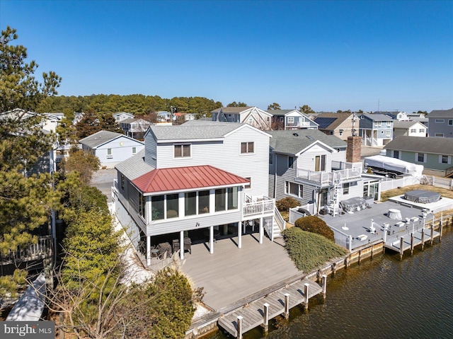 drone / aerial view featuring a residential view and a water view