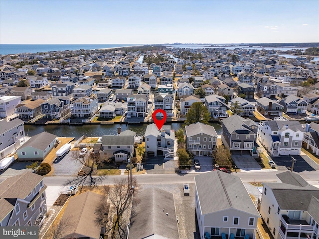 bird's eye view featuring a water view and a residential view