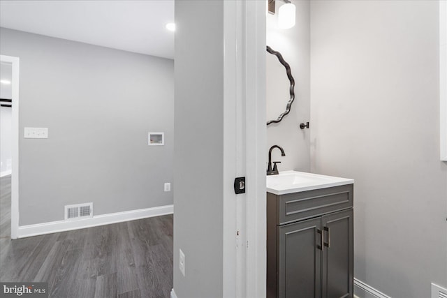 bathroom with hardwood / wood-style flooring and vanity