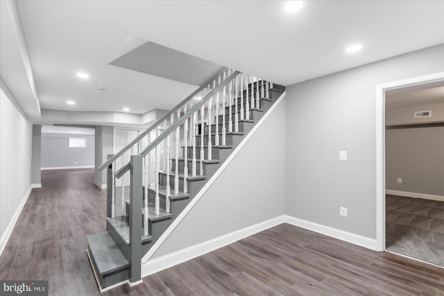 stairway with hardwood / wood-style flooring