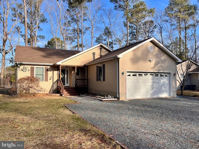 view of front of house with a garage, driveway, roof with shingles, and a front yard