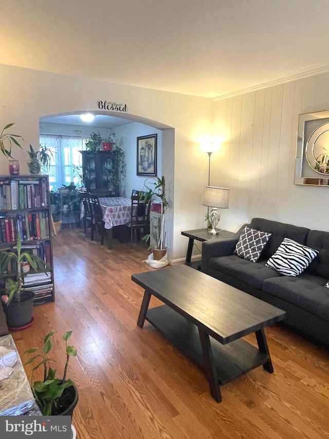 living room with hardwood / wood-style floors and ornamental molding