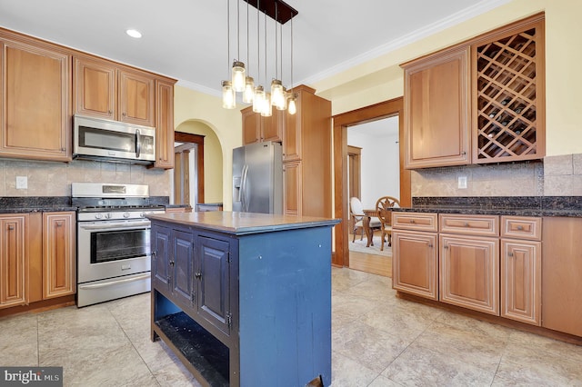 kitchen with stainless steel appliances, a center island, decorative light fixtures, tasteful backsplash, and crown molding