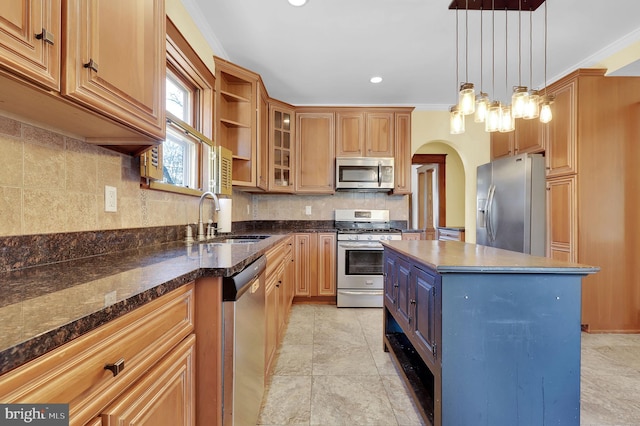 kitchen featuring sink, a center island, pendant lighting, stainless steel appliances, and decorative backsplash