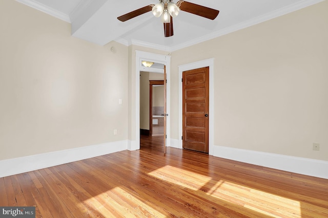 spare room with hardwood / wood-style flooring, ornamental molding, and ceiling fan