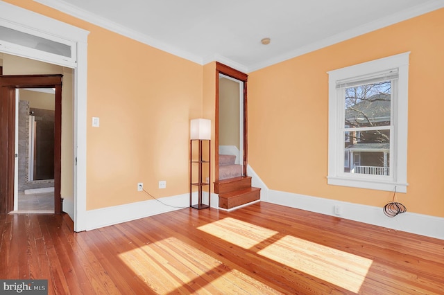 unfurnished room featuring ornamental molding and hardwood / wood-style floors