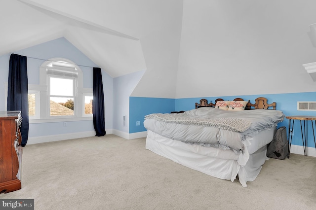 carpeted bedroom with vaulted ceiling