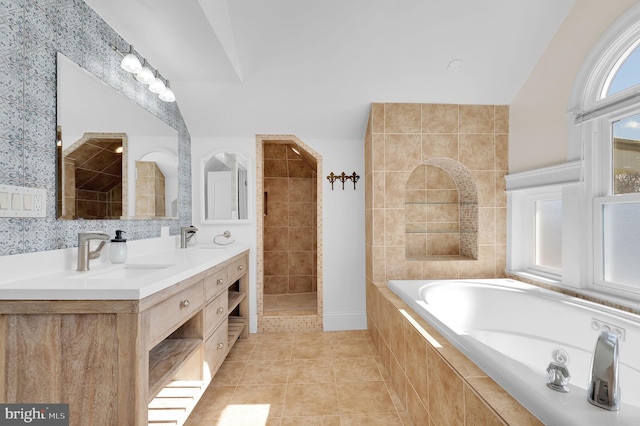 bathroom featuring separate shower and tub, vanity, tile patterned flooring, and lofted ceiling