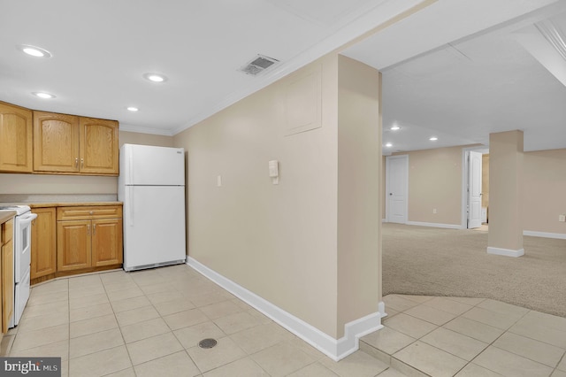 kitchen with white appliances, crown molding, and light colored carpet