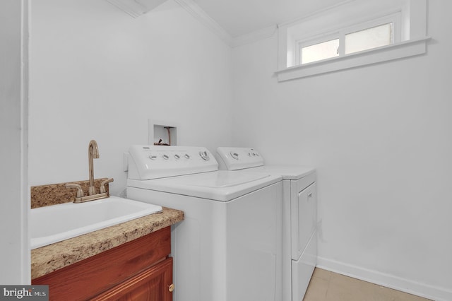 laundry room with washing machine and dryer, sink, and crown molding