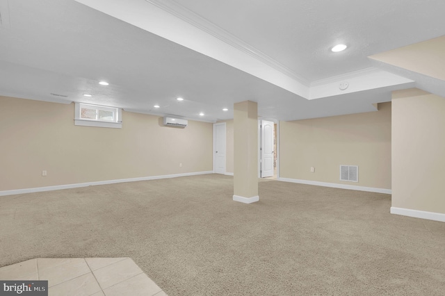 basement with light carpet, crown molding, and a wall unit AC