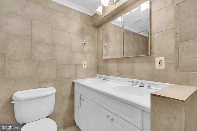 bathroom with vanity, toilet, and ornamental molding