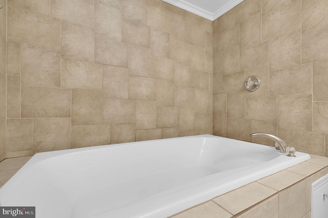 bathroom with tiled bath and ornamental molding