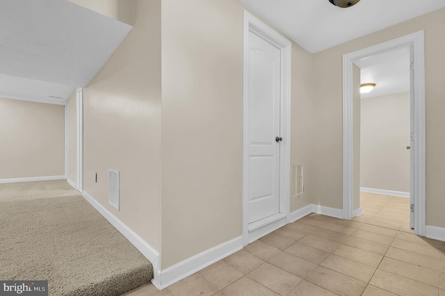 corridor with light tile patterned flooring