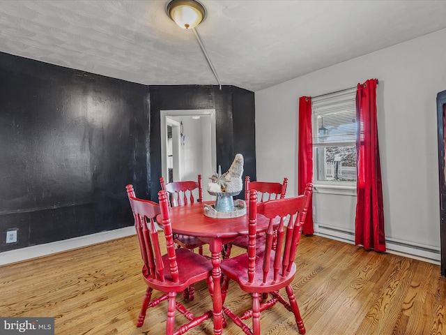 dining room with wood-type flooring