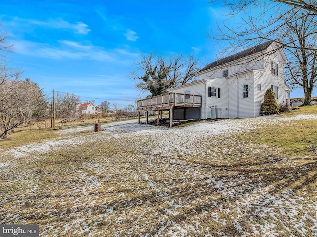 view of side of home with a wooden deck