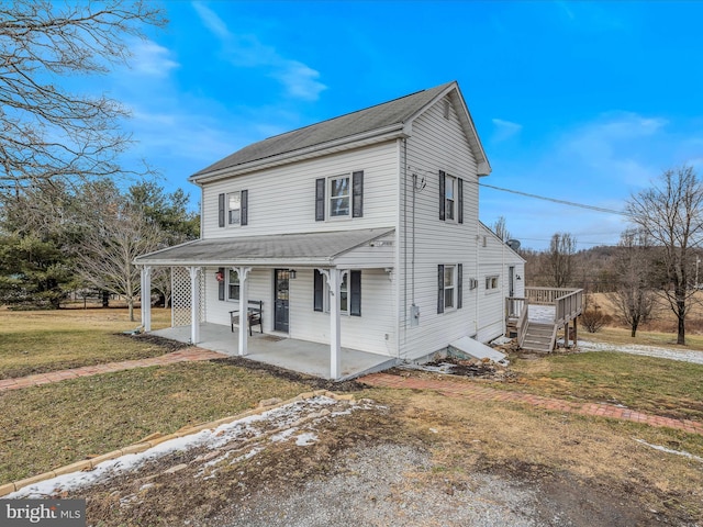 view of front of property featuring a front lawn and a patio area