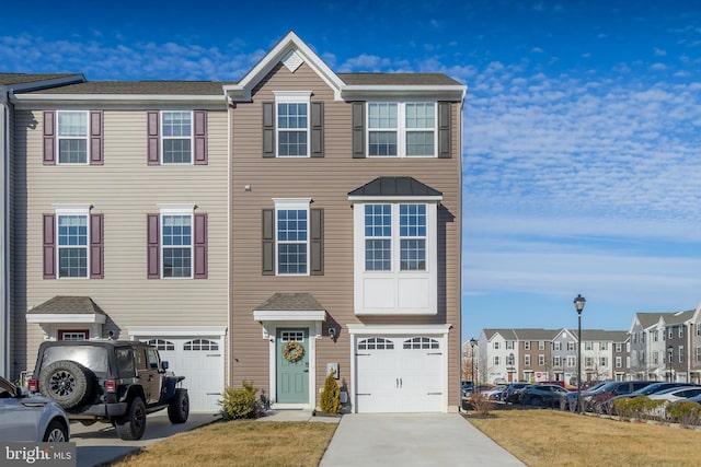 view of property featuring a garage and a front yard