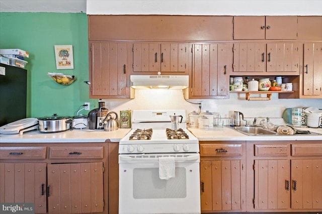 kitchen featuring sink and white gas stove