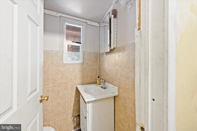 bathroom featuring vanity and tile walls