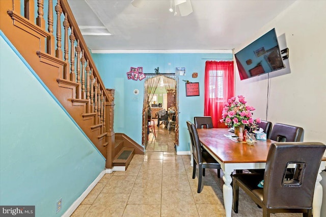dining area with ceiling fan, ornamental molding, and light tile patterned floors