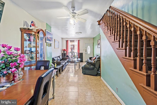 tiled dining space featuring ceiling fan